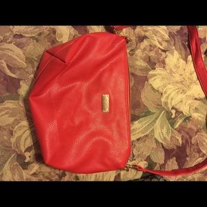 New red BCBG purse with gold accents.